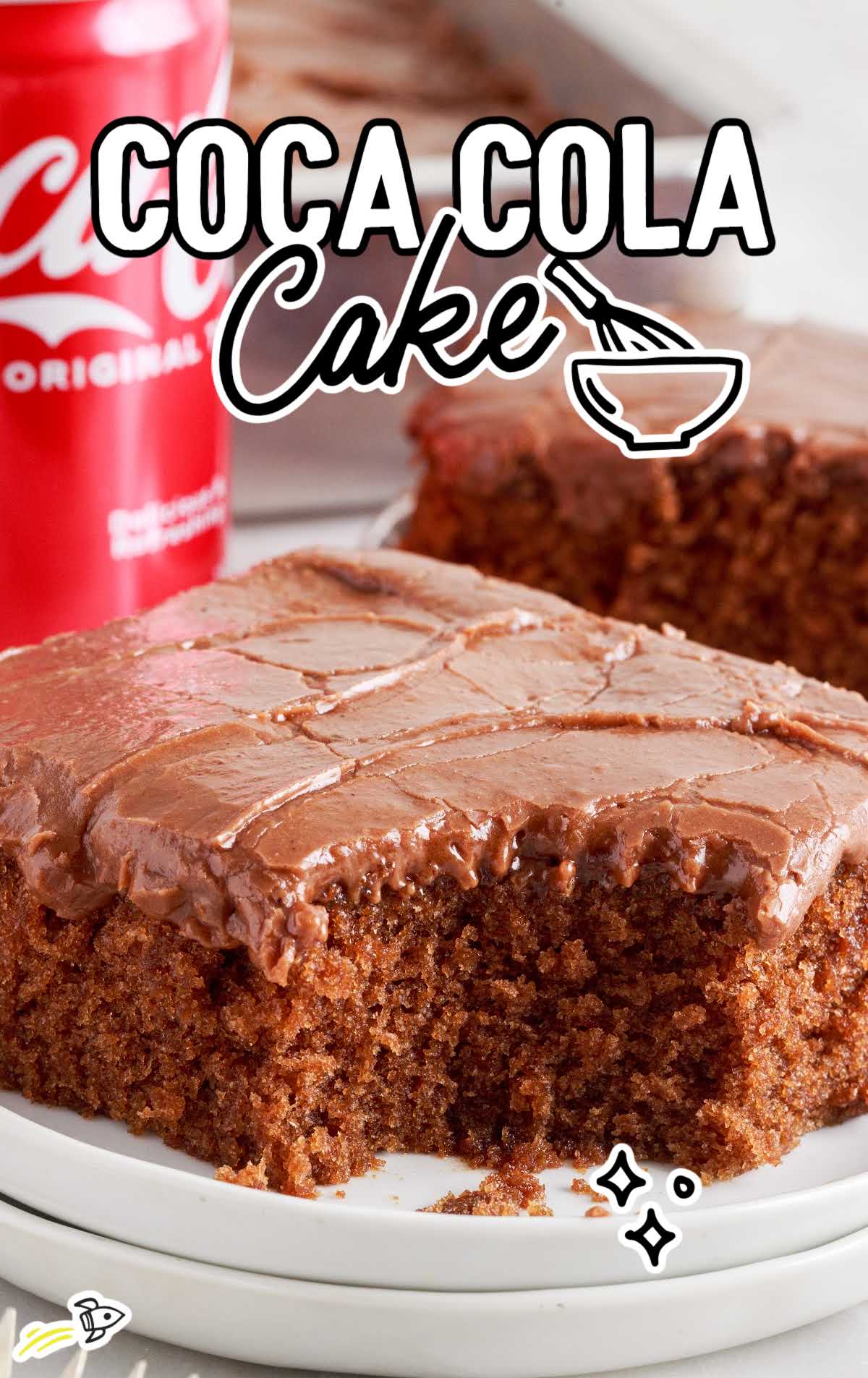a close up shot of a slice of Coca Cola Cake on a plate with a bite taken out of it
