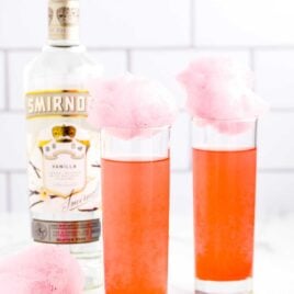 a close up shot of Cotton Candy Cocktails topped with cotton candy