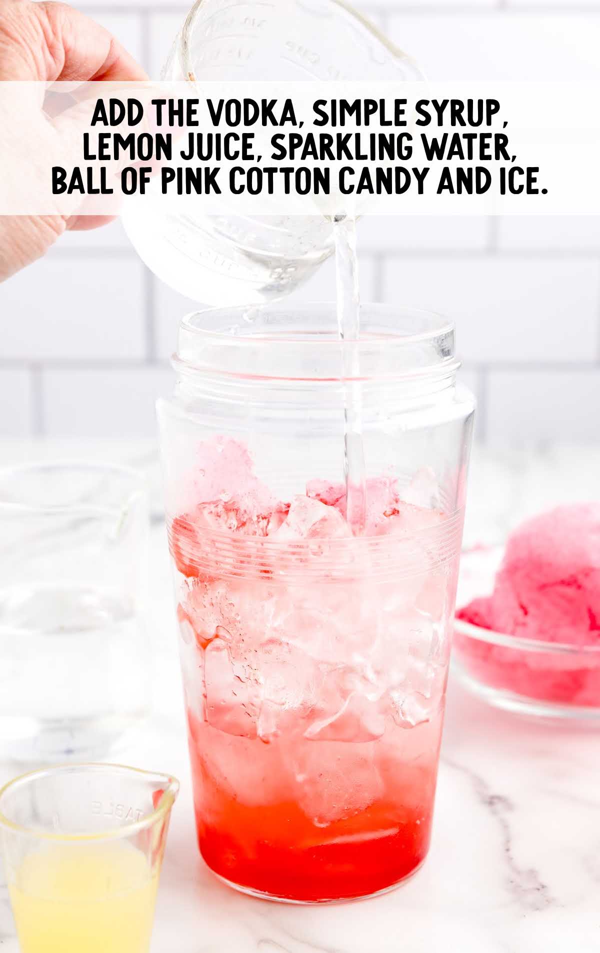 vodka, simple syrup, lemon juice, sparkling water, ice and pink cotton candy added to a shaker