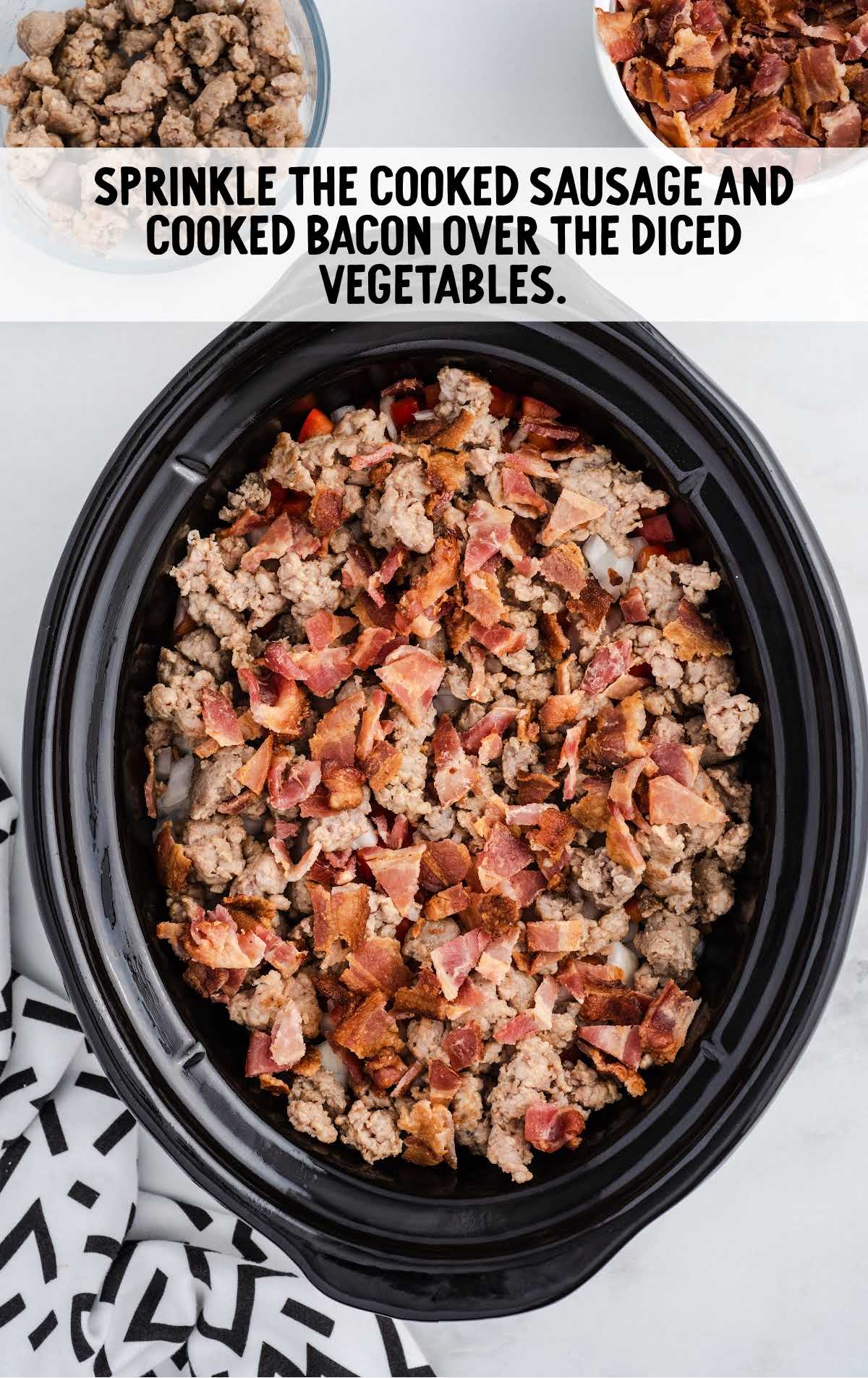 cooked sausage and cooked bacon sprinkled over the vegetable in a crockpot