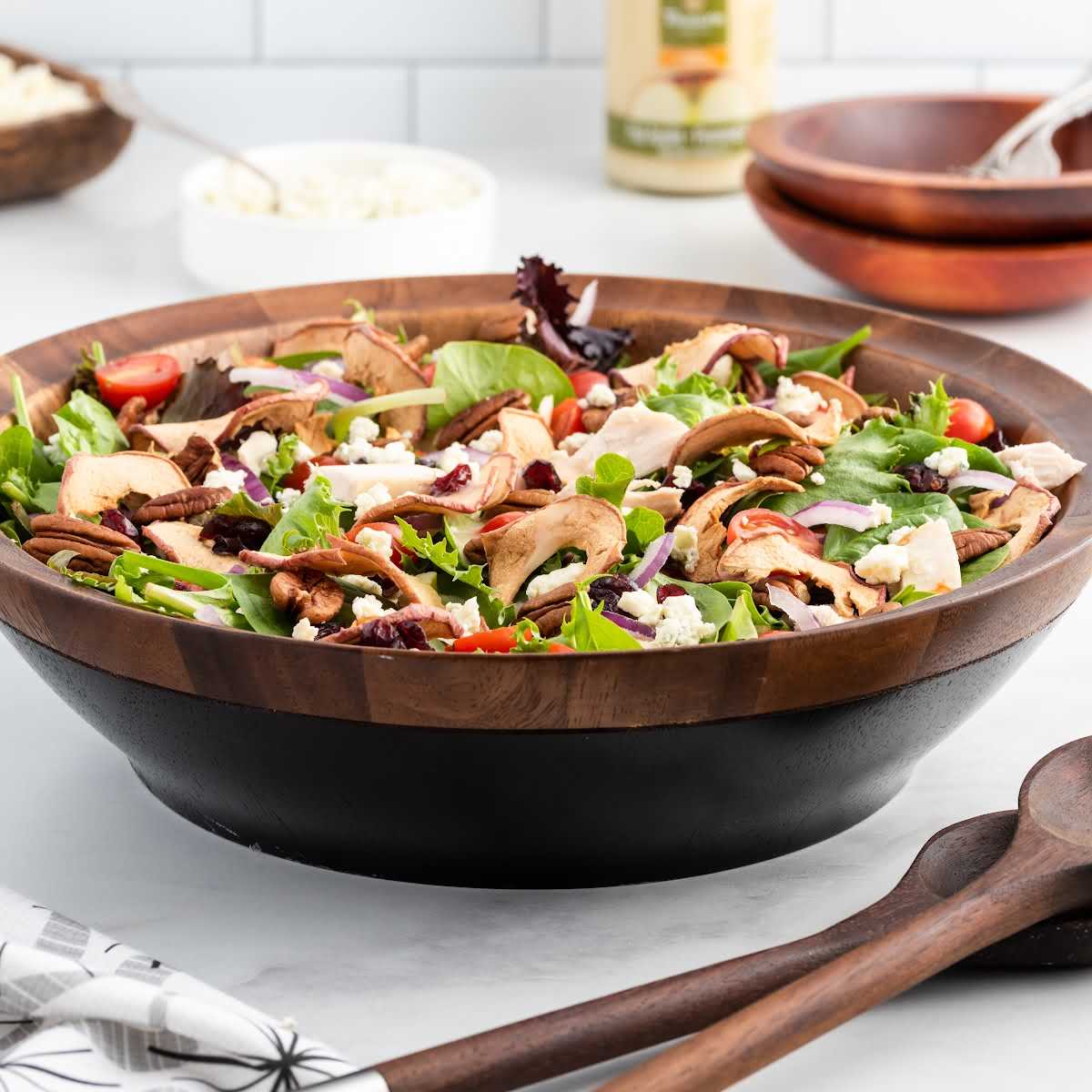 a close up shot of Fuji Apple Panera Salad in a wooden bowl