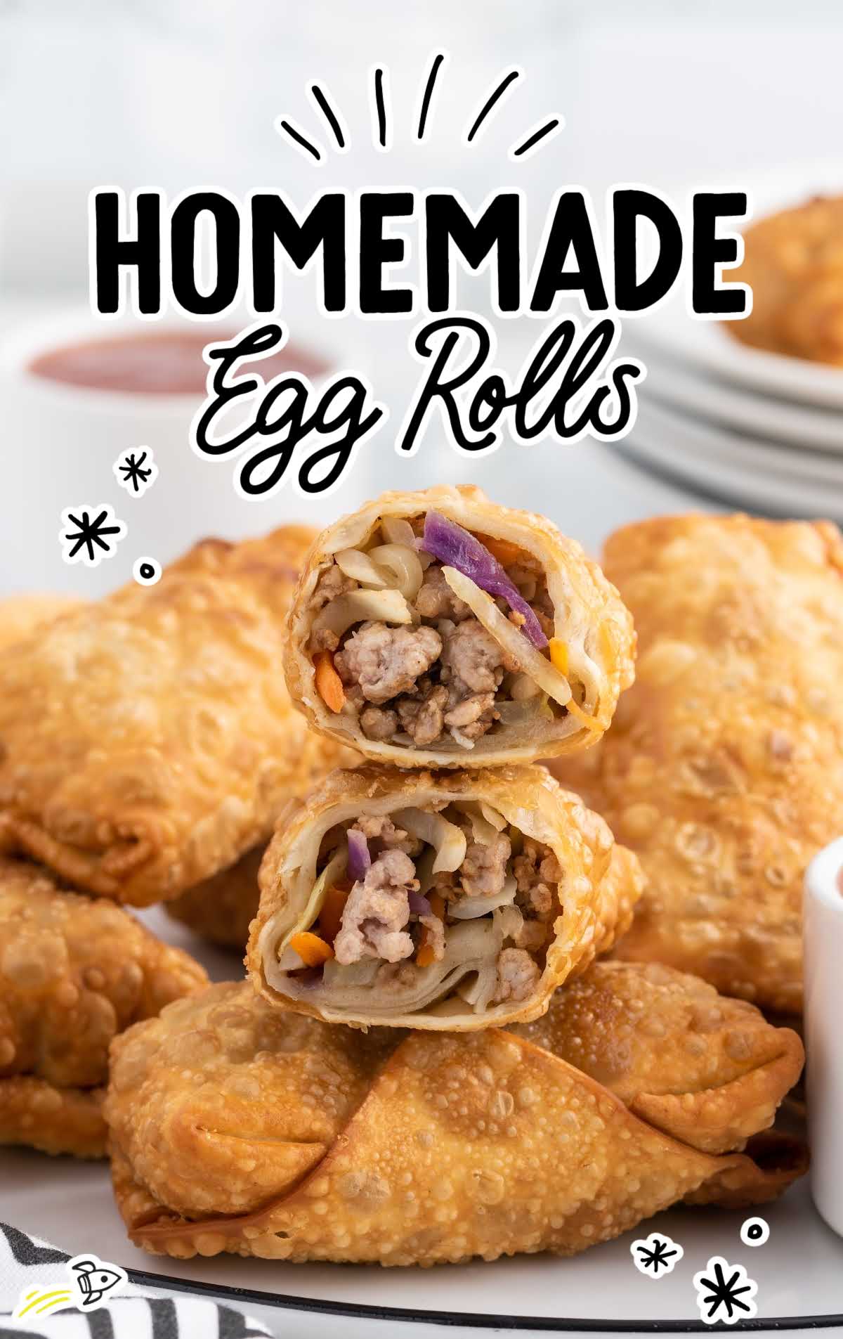 a close up shot of Homemade Egg Rolls with one split in half on a plate