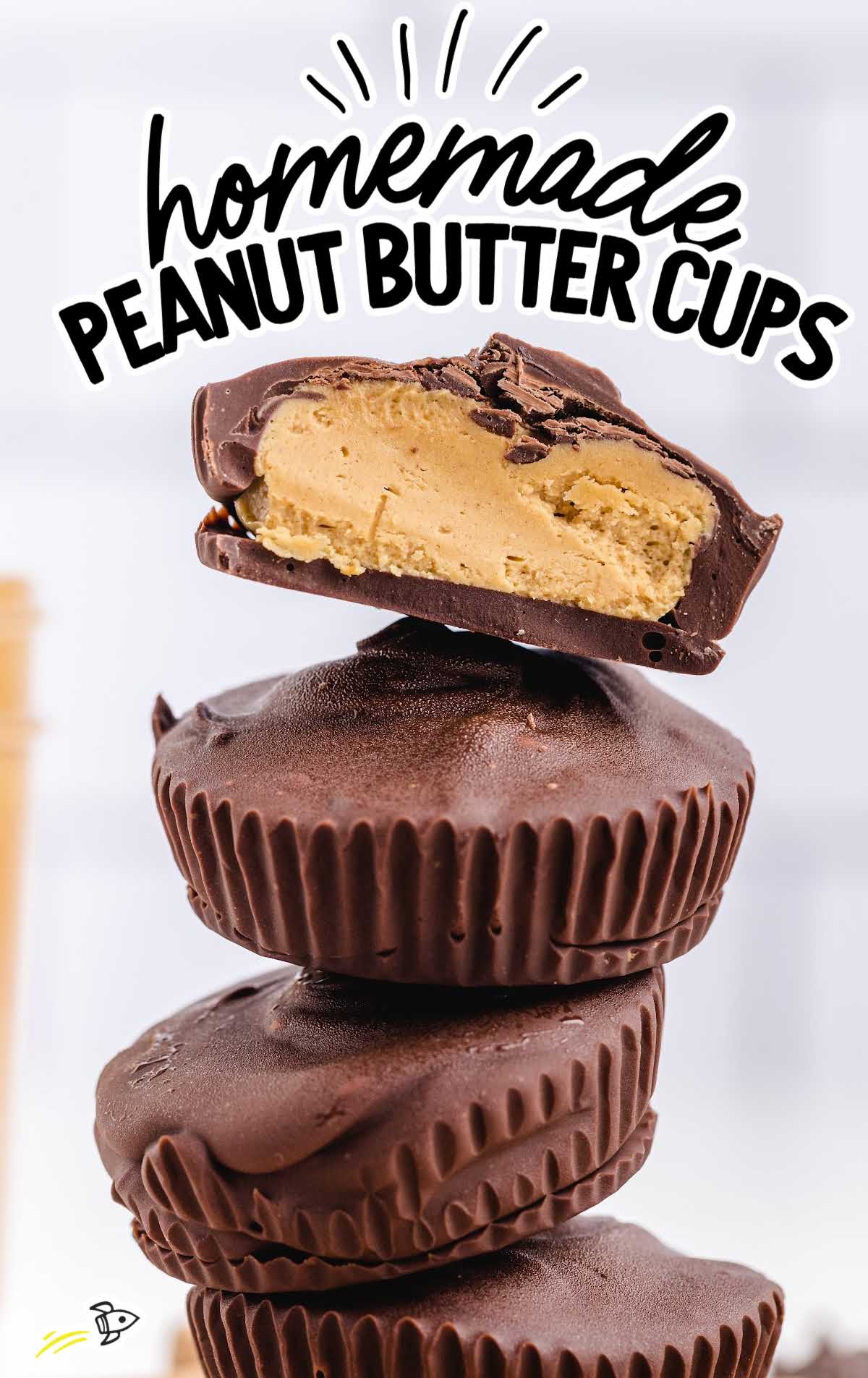 a close up shot of Homemade Peanut Butter Cups stacked on top of each other with one having a bite taken out of it