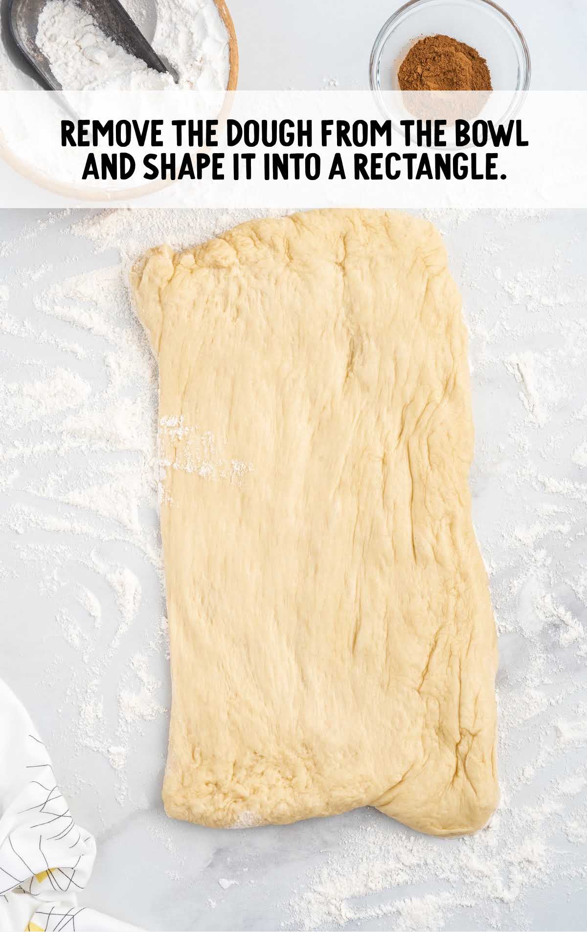 dough removed from bowl and shaped into a rectangle