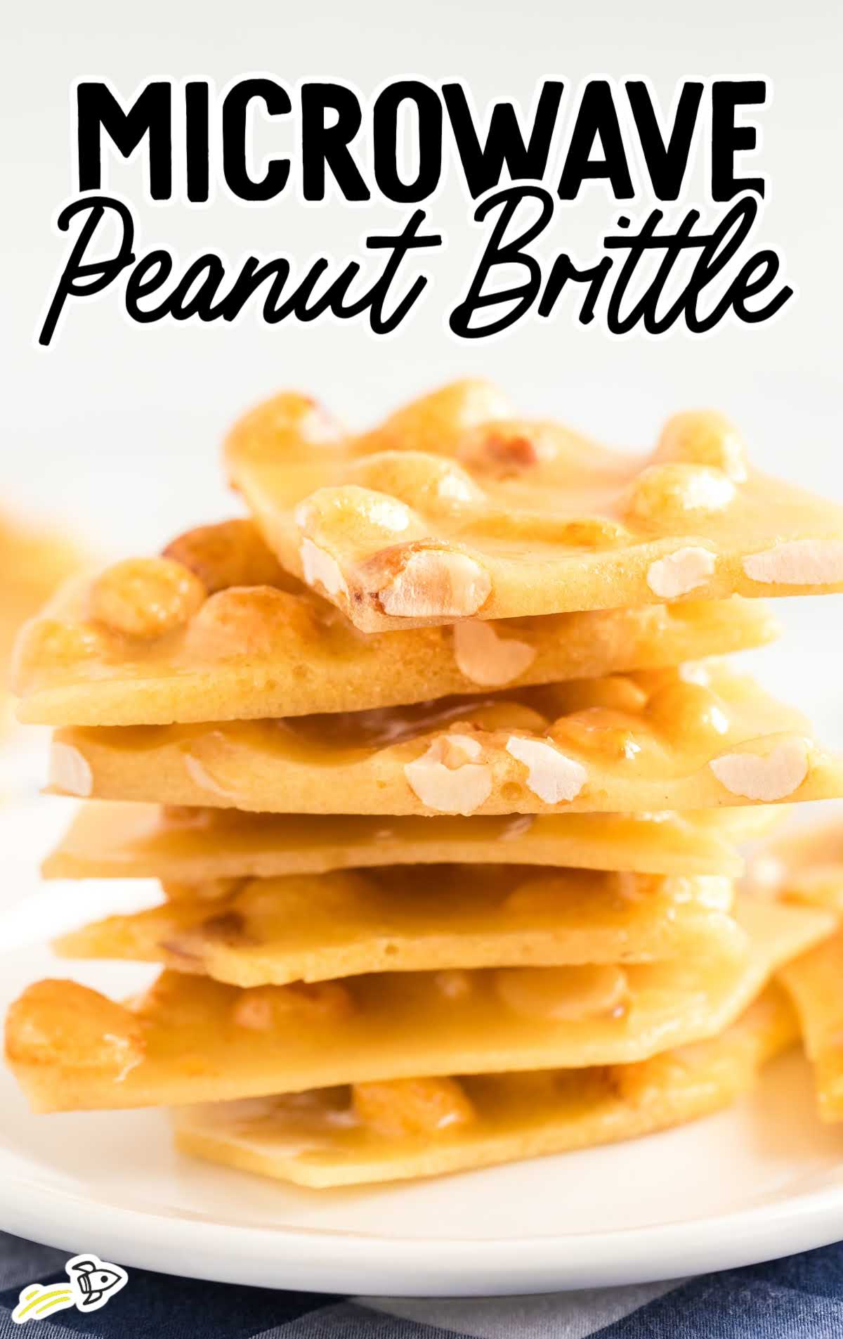 A close up shot of Microwave Peanut Brittle on a plate stacked on top of each other  