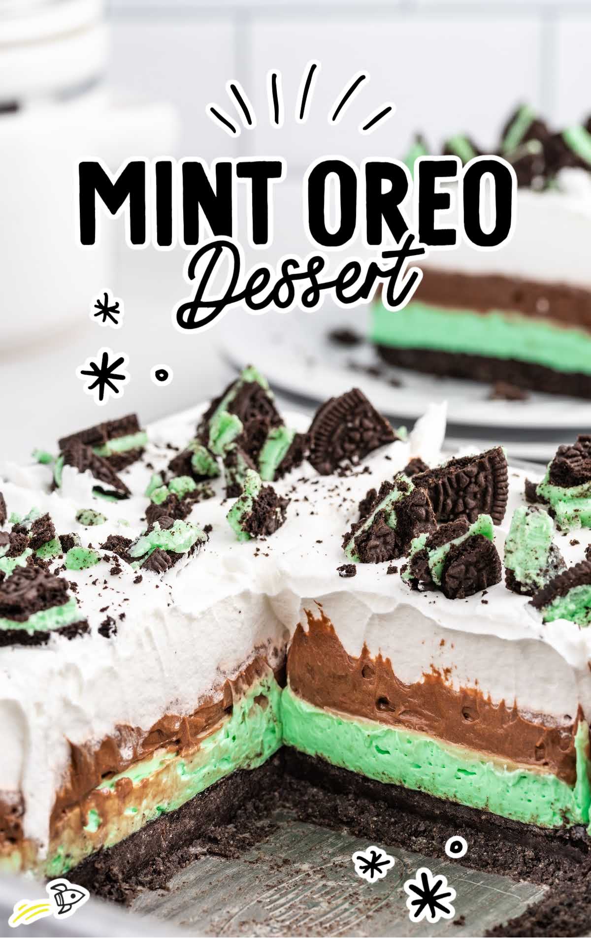 a close up shot of Mint Oreo Dessert in a baking dish with a slice taken out