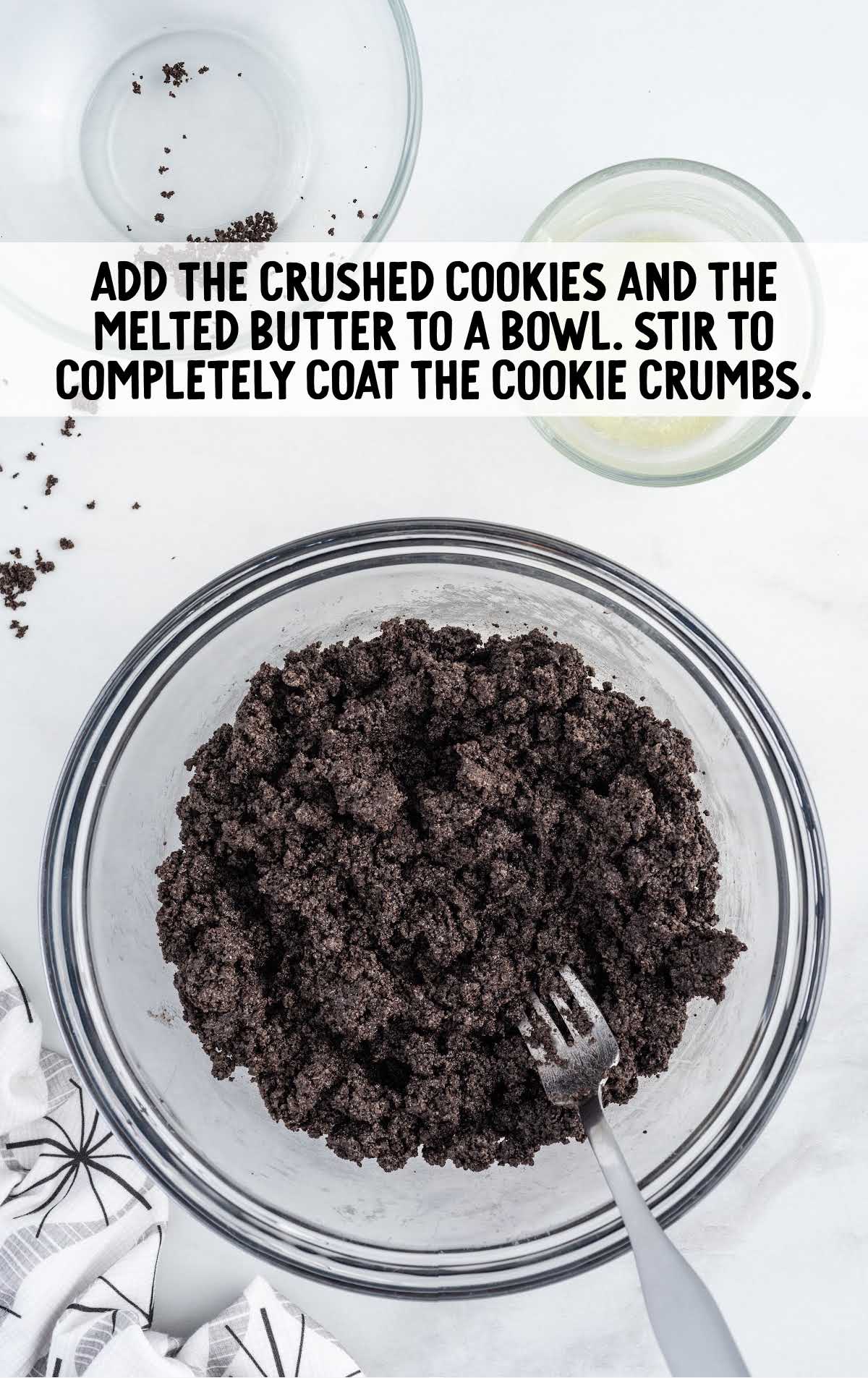 crushed cookies and melted butter stirred in a bowl