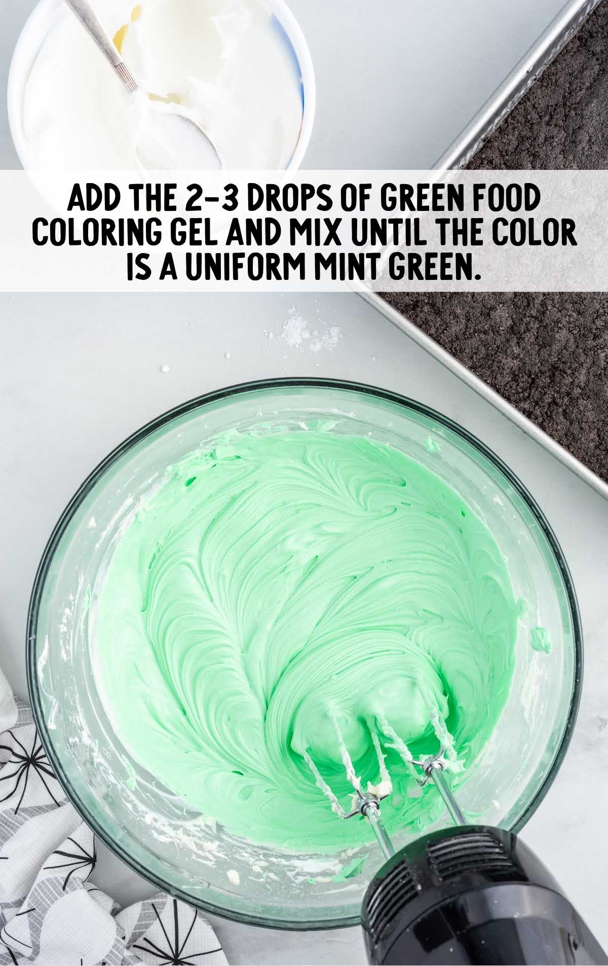 green food drop blended to the mixture in a bowl