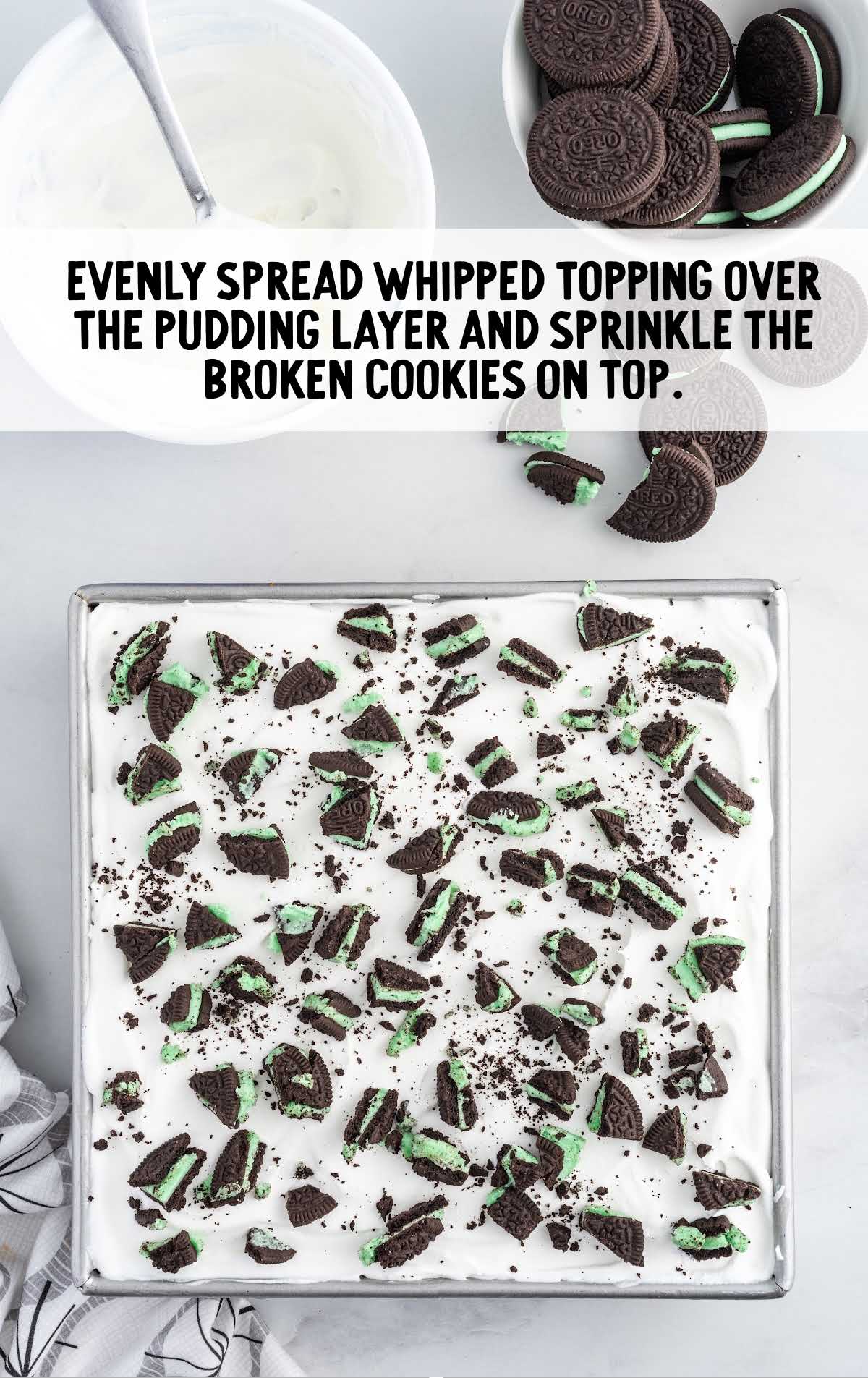 whipped topping spread over the puding layer and sprinkle broken cookies on top