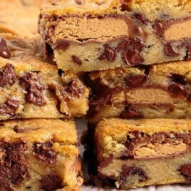 a close up shot of Peanut Butter Cup Cookie Bars stacked on top of each other