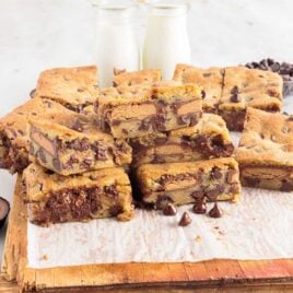 a close up shot of Peanut Butter Cup Cookie Bars on a wooden board
