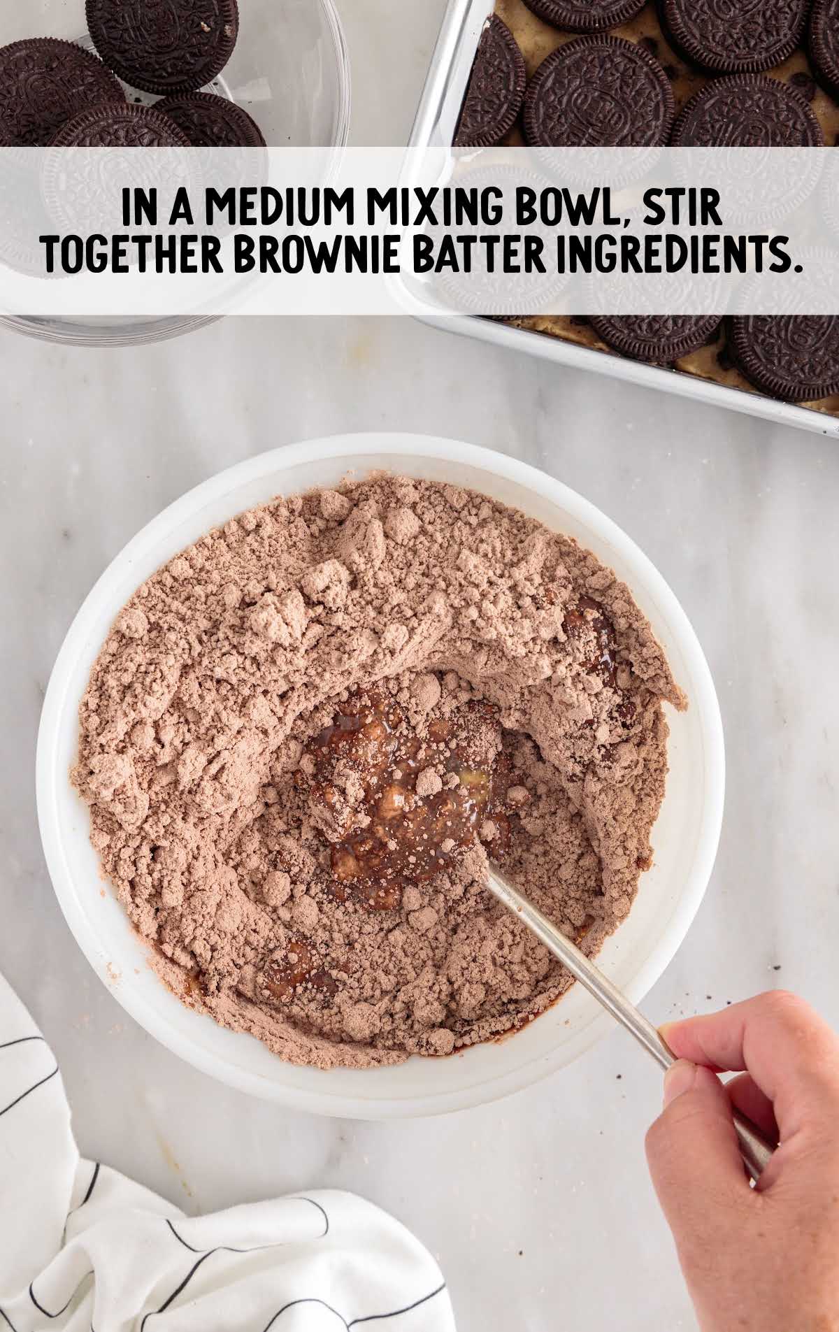 brownie batter ingredients stirred in a bowl