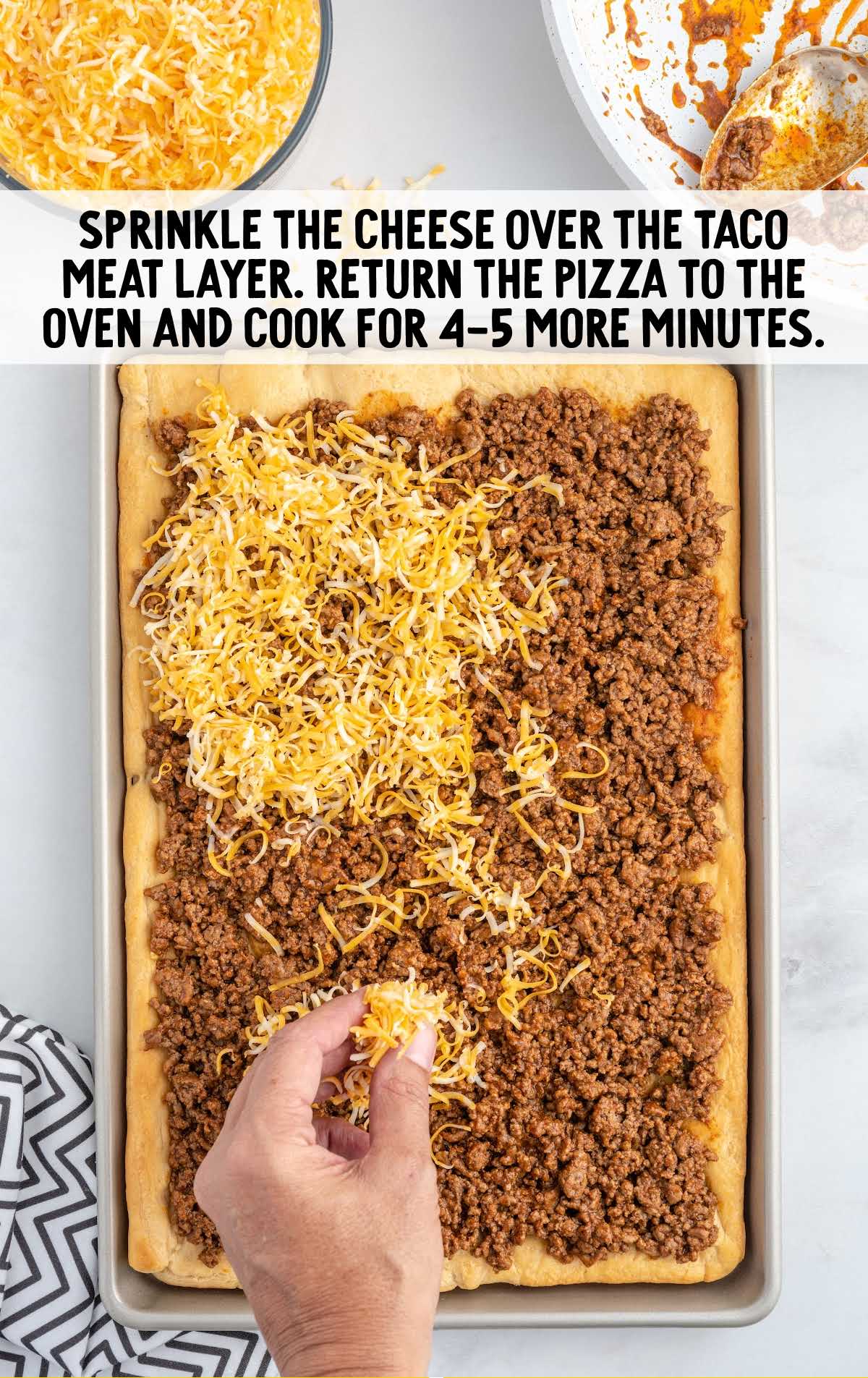cheese sprinkled over the taco meat layer