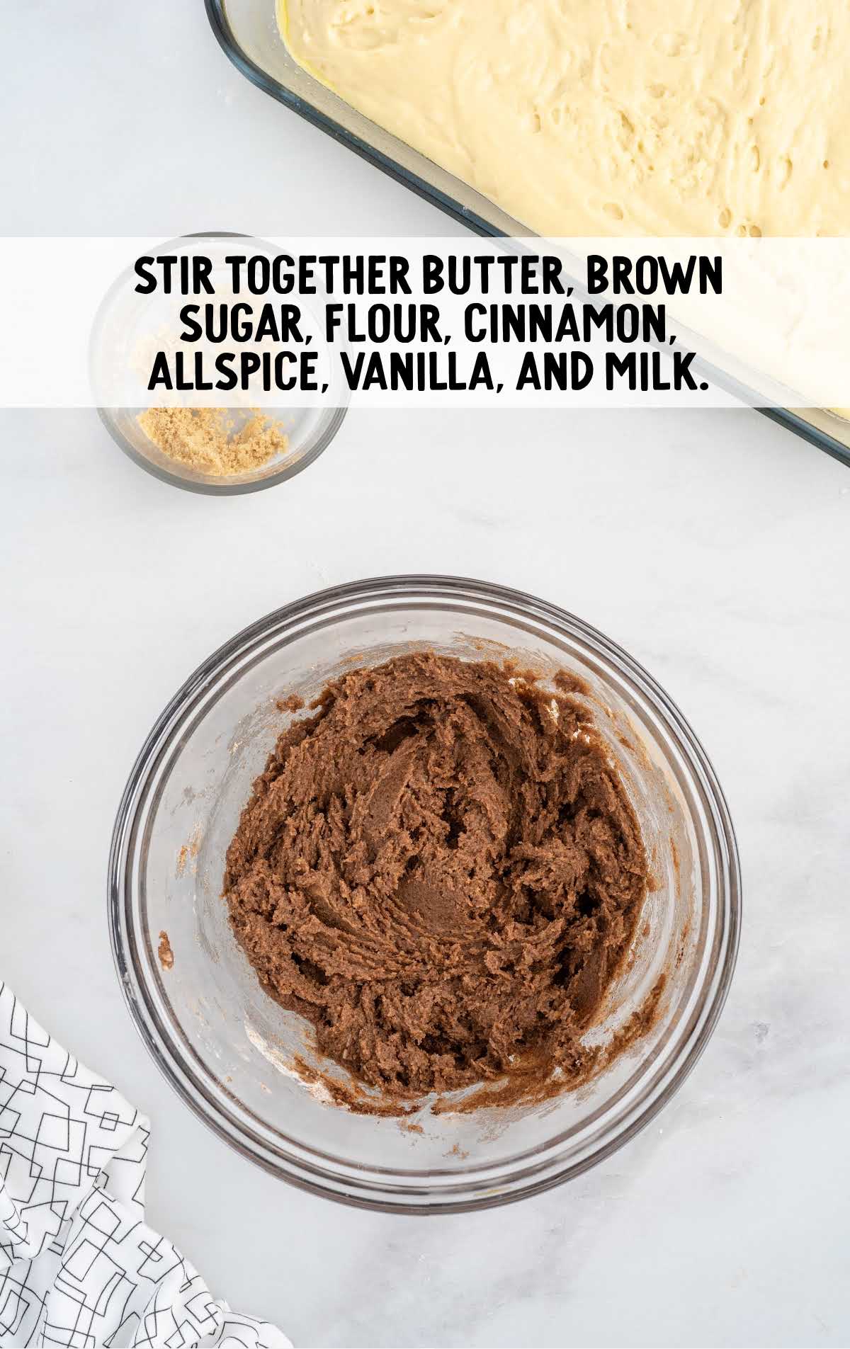 butter, brown sugar, flour, cinnamon, allspice, vanilla, and milk stirred in a bowl