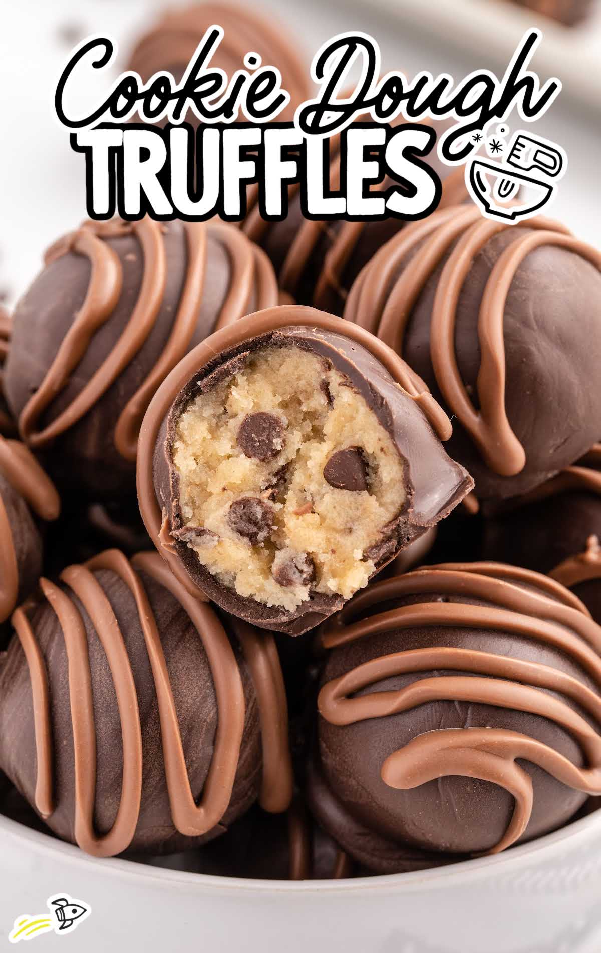 close up shot of Cookie Dough Truffles in a bowl with one having a bite taken out