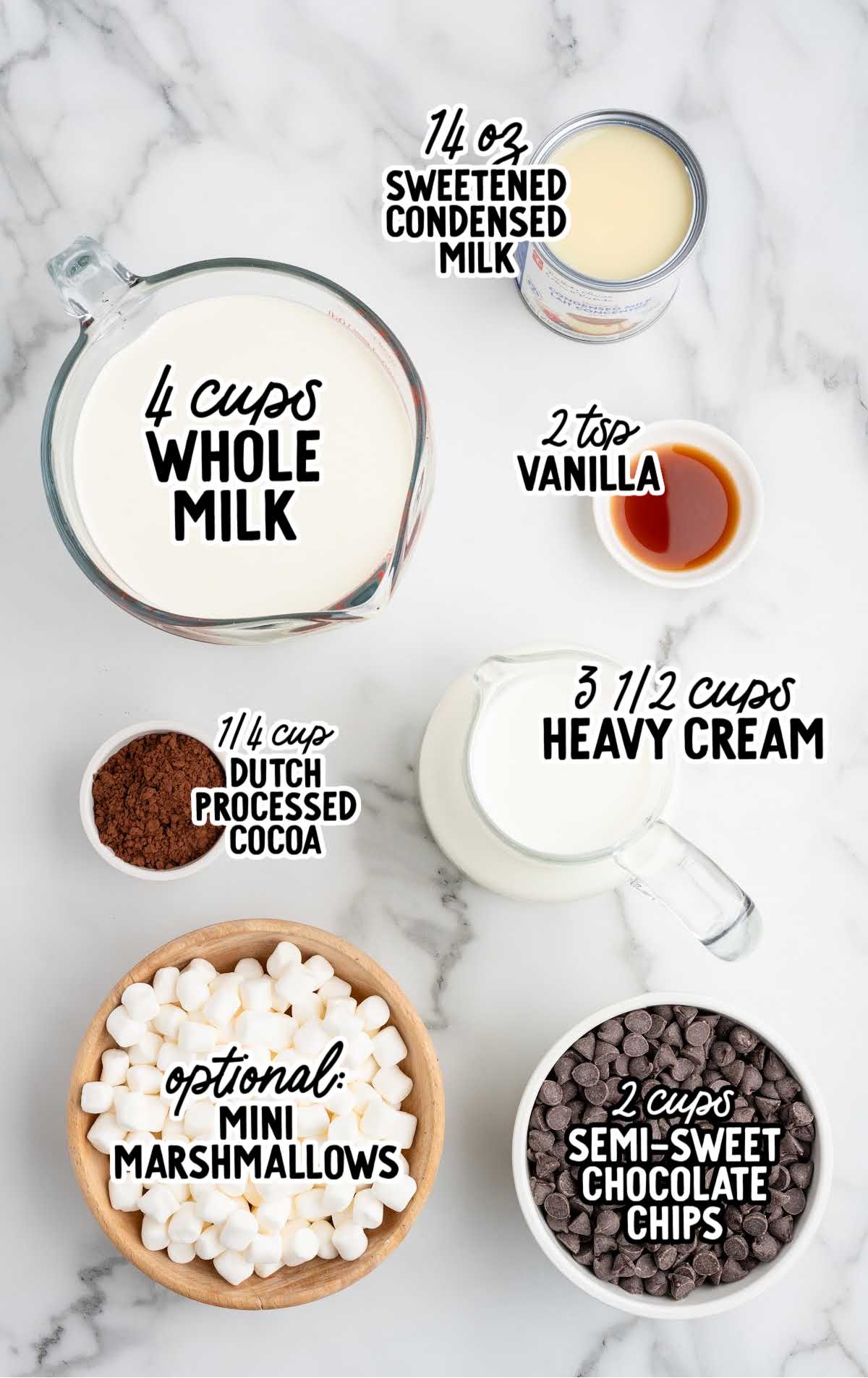 Overhead view of ingredients for crockpot hot chocolate including milk, heavy cream, cocoa powder, sweetened condensed milk, vanilla, chocolate chips, and marshmallows.