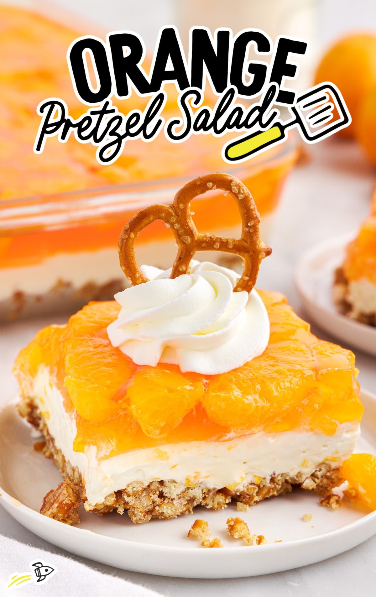 A slice of orange pretzel salad on a white dessert plate. 