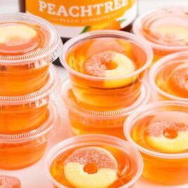 close up shot of Peach Jello Shots on a tray and stacked on top of each other