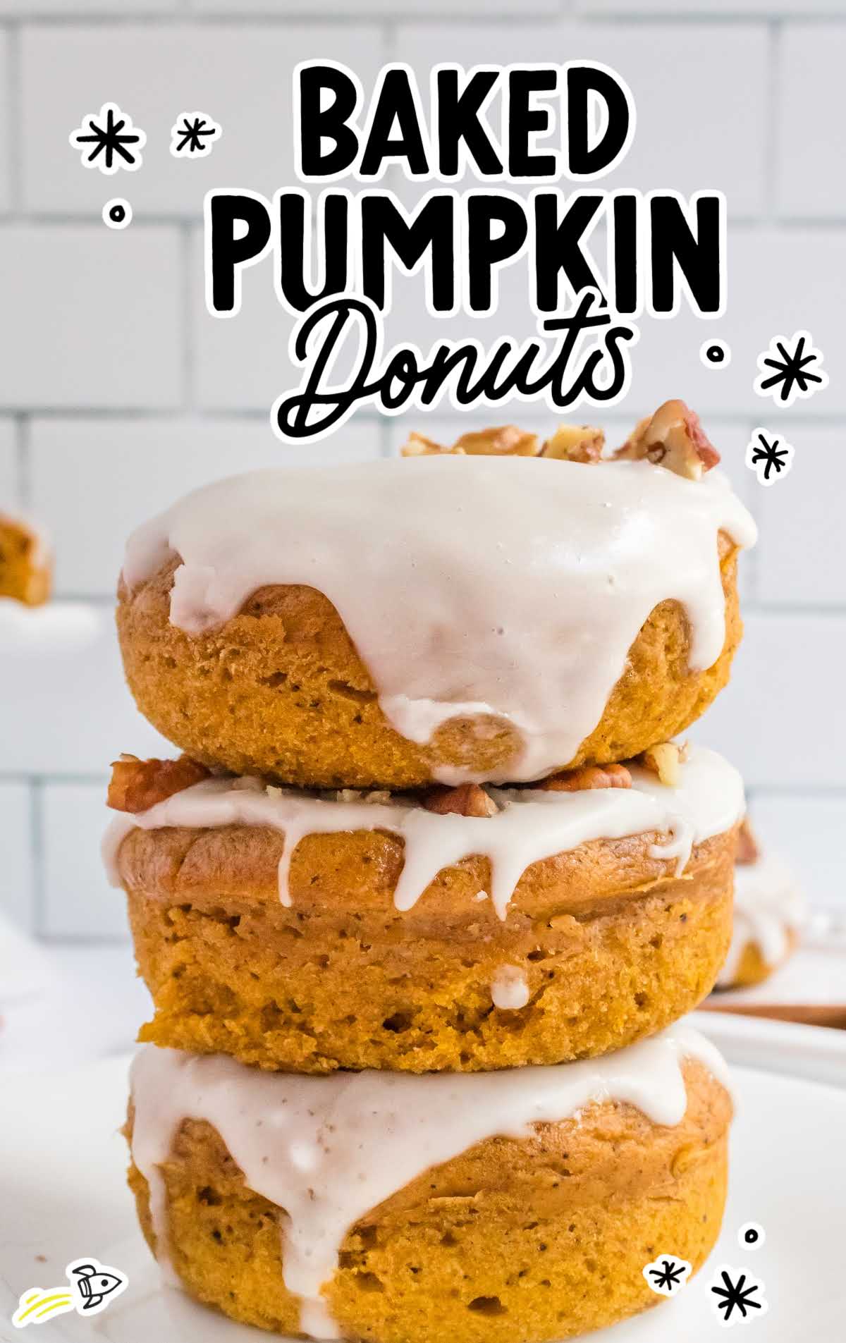 a close up shot of Baked Pumpkin Donuts stacked on top of each other