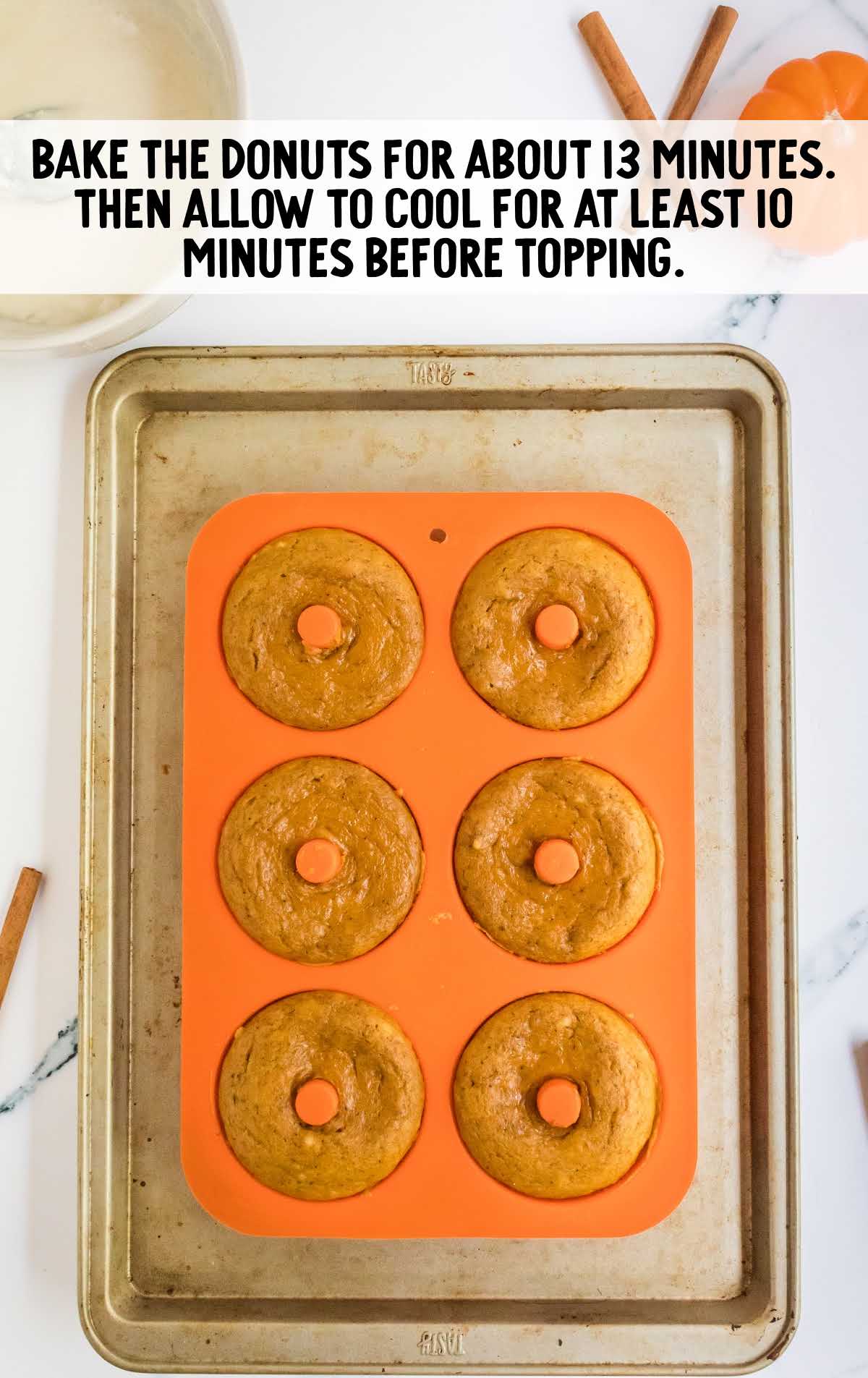 Baked Pumpkin Donuts baked on a baking sheet