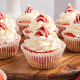 a close up shot of Candy Cane Cupcakes on a wooden board