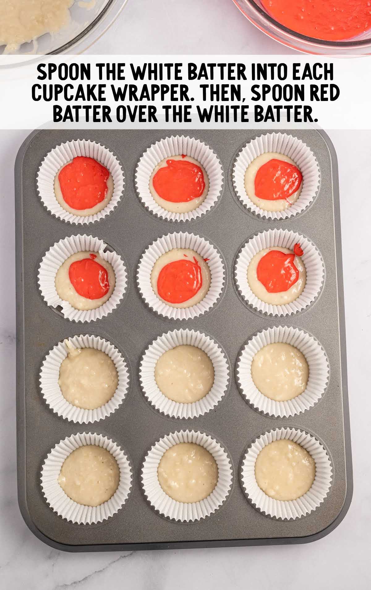 white and red batter spooned into each cupcake wrapper