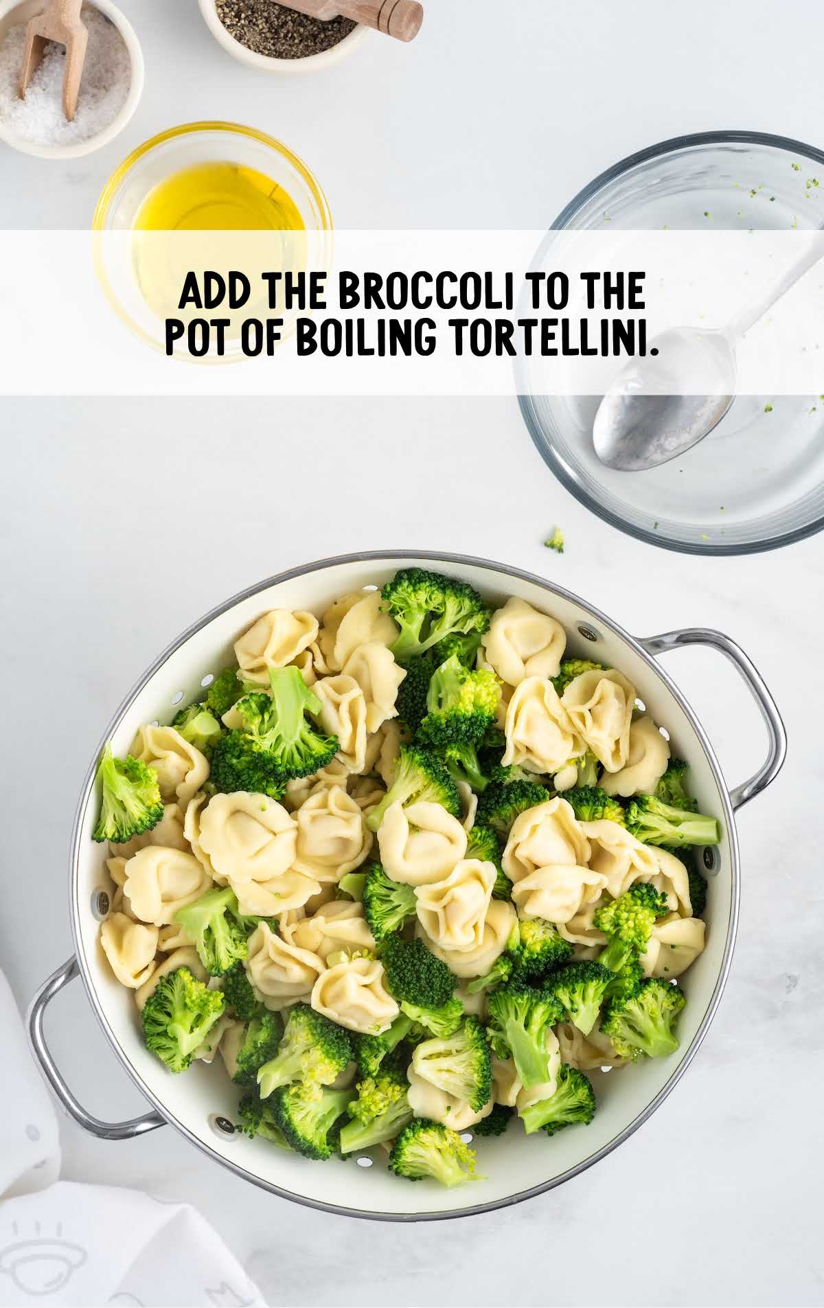 broccoli added to the pot of boiling tortellini