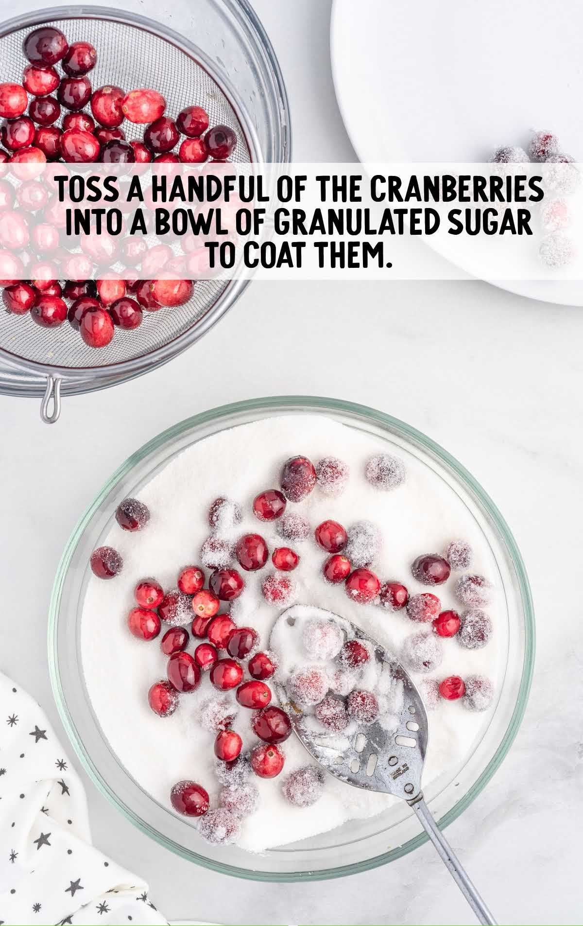 cranberries tossed into the granulated sugar in a bowl