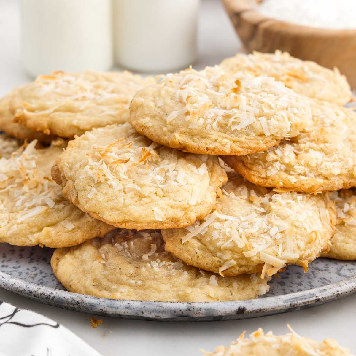 a close up shot of Coconut Cookies on top of each other on a platter