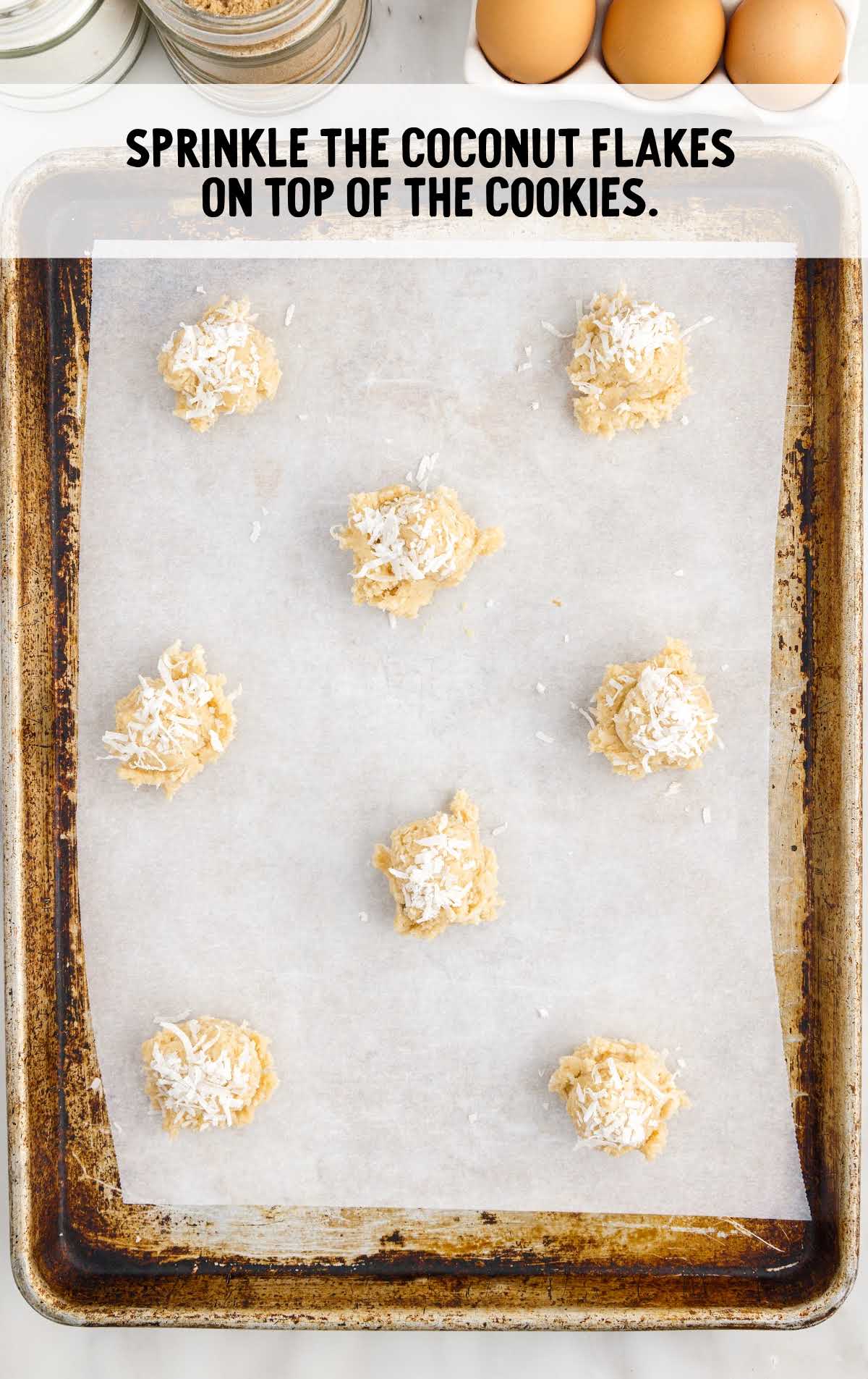 coconut flakes sprinkled on top of the cookies