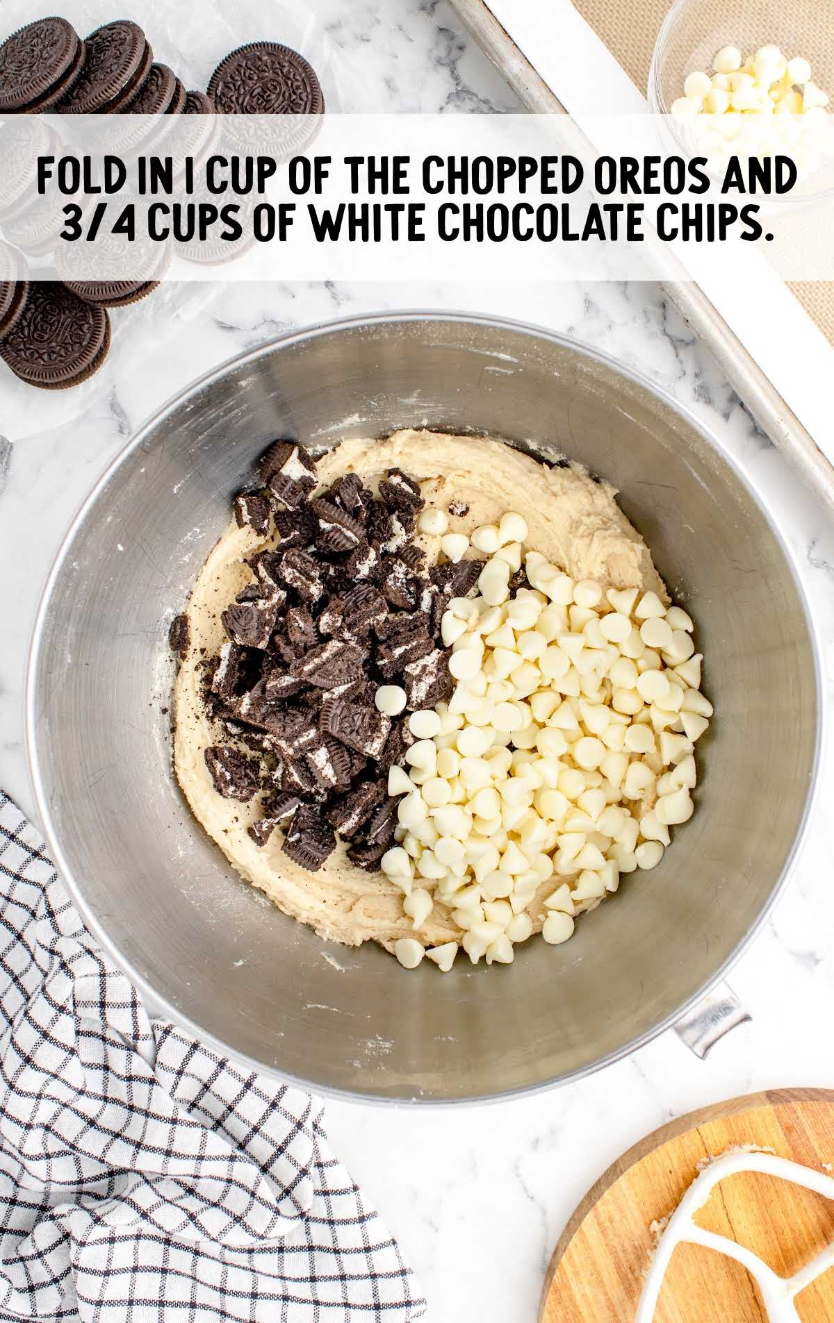 chopped oreos and white chocolate chips folded in a bowl