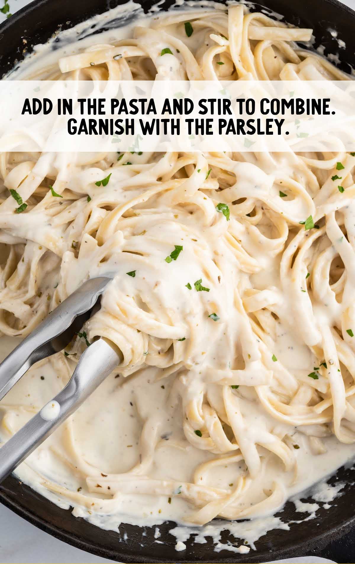 pasta added and parsley and stirred in a pan