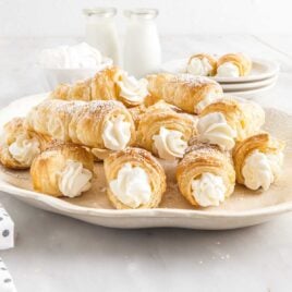 a close up shot of Cream Horns on a plate