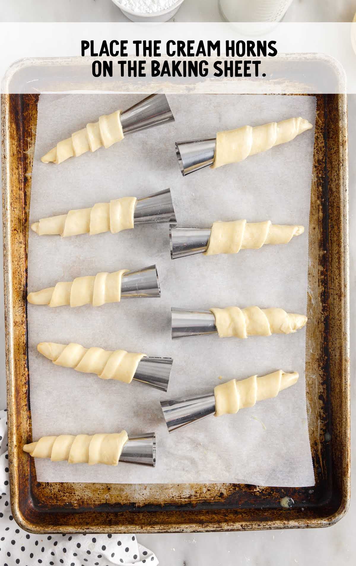 cream horns placed in a baking sheet