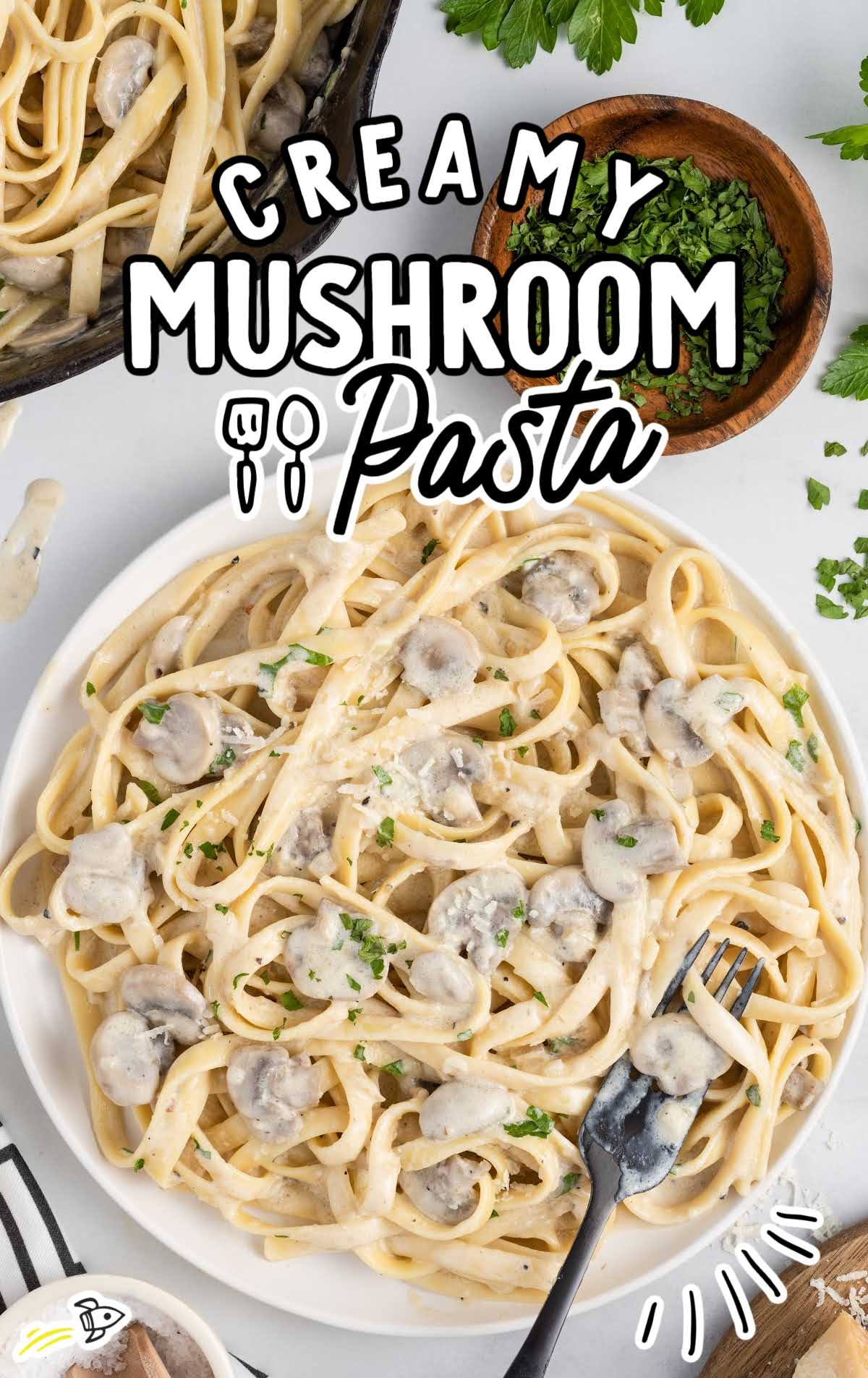 overhead shot of Creamy Mushroom Pasta on a plate with a fork grabbing a piece