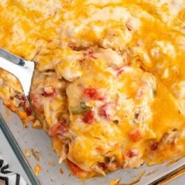 a close up shot of King Ranch Chicken Casserole with a sptula grabbing a piece