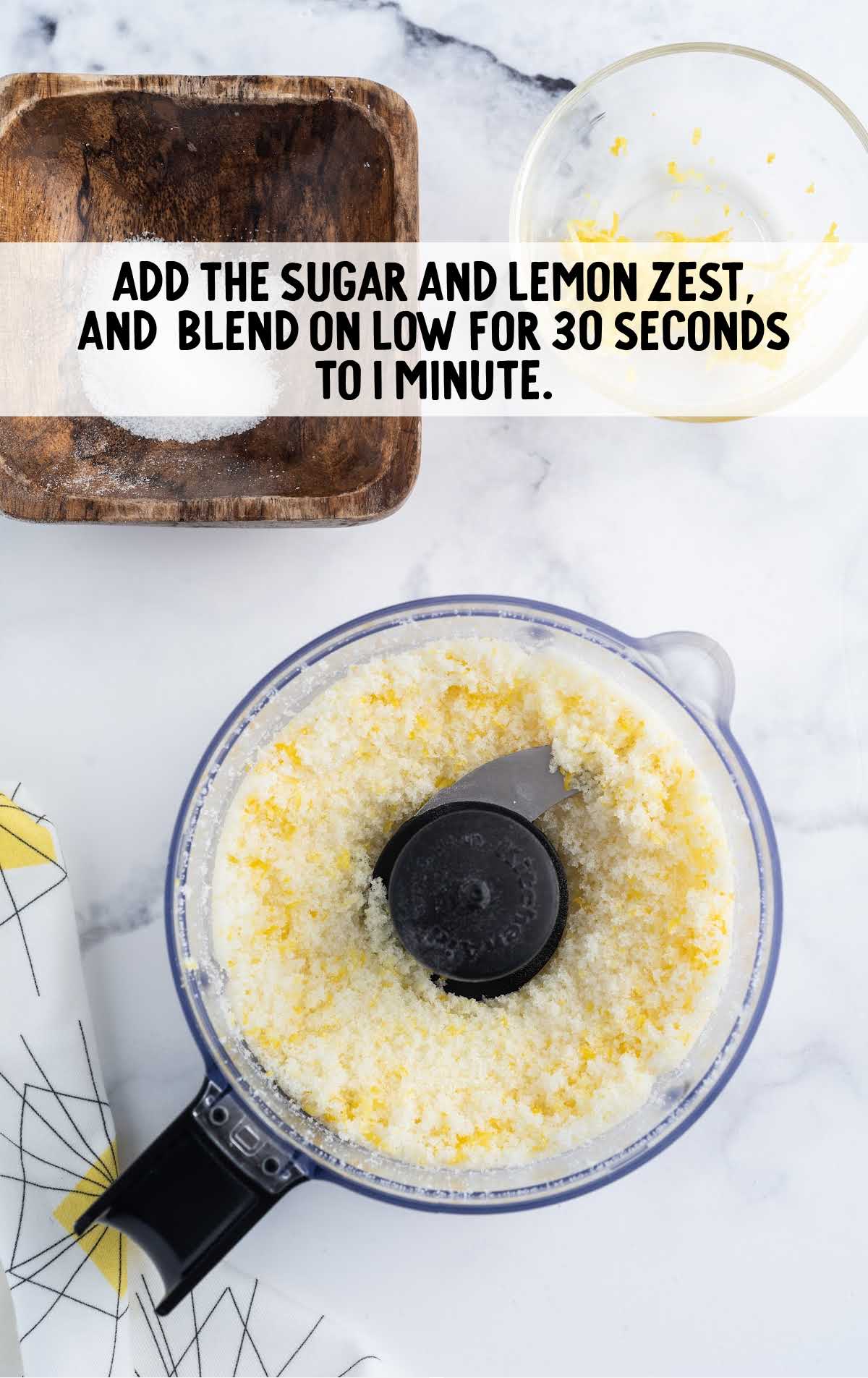 sugar and lemon zest added to a blender