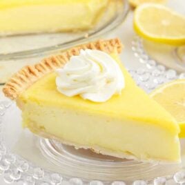 a close up shot of a slice of Lemon Custard Pie on a plate