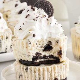 a close up shot of Mini Oreo Cheesecakes stacked on a plate