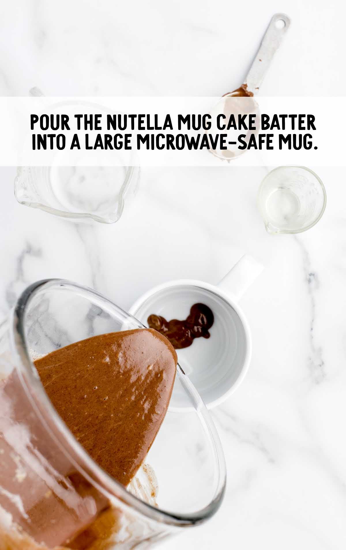 nutella mug cake batter poured into a microwave safe mug
