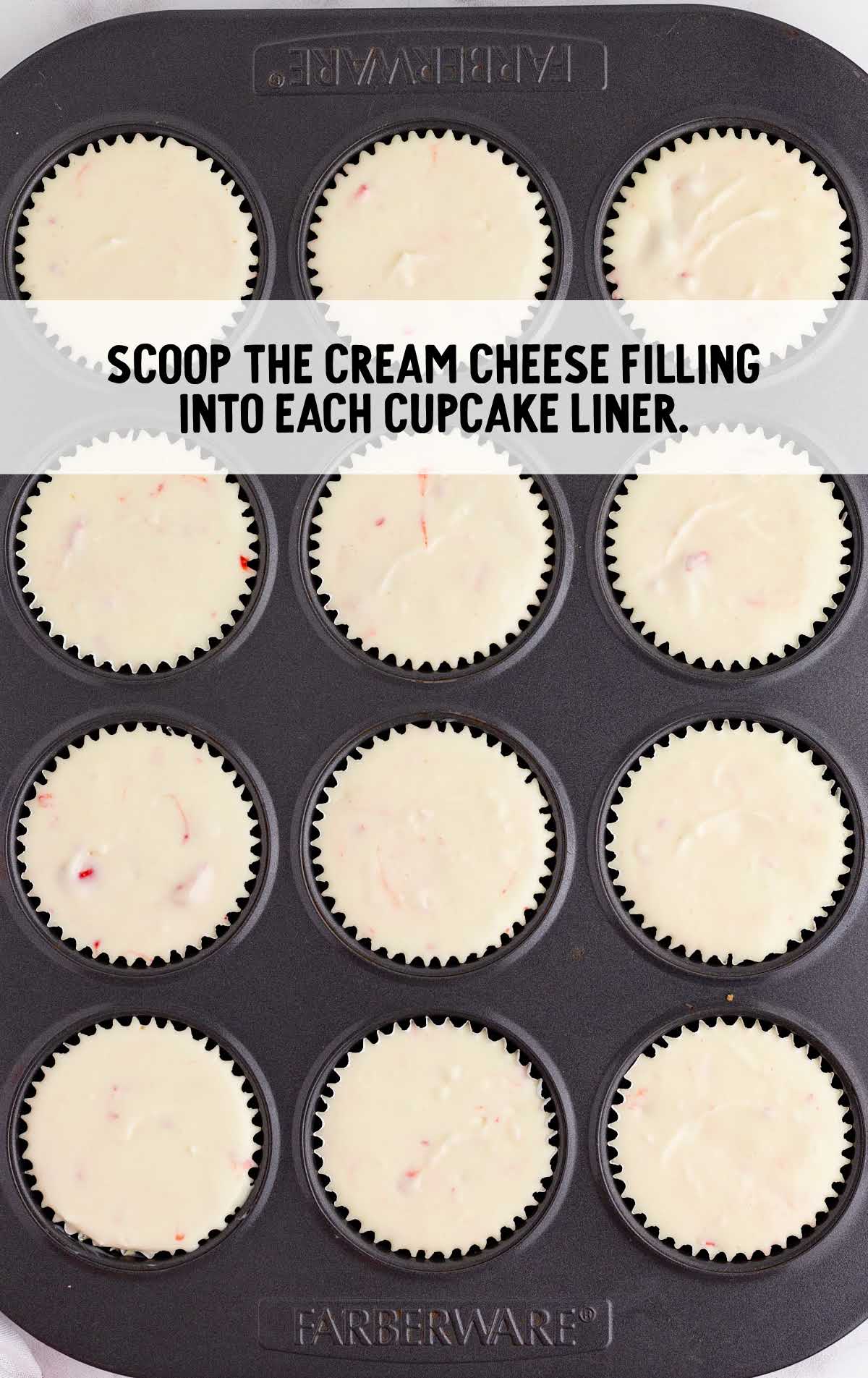 cream filling scooped into cupcake liners