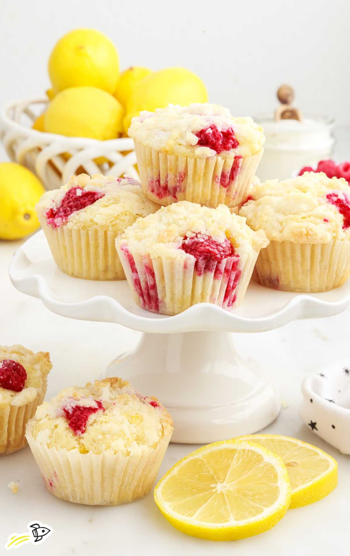 a close up shot of Raspberry Lemon Muffins on a cake stand