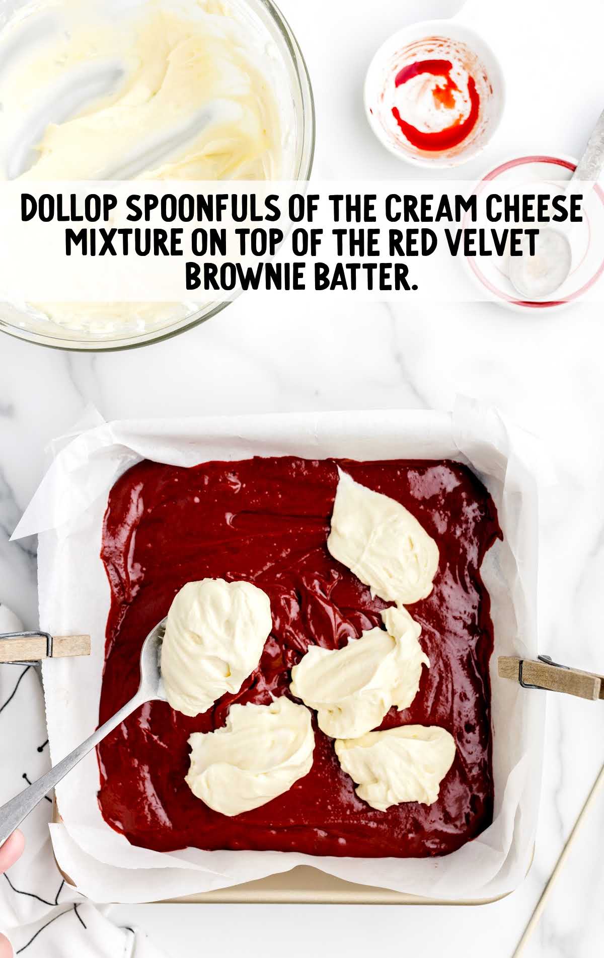 cream cheese dollop on top of the red velvet brownie batter