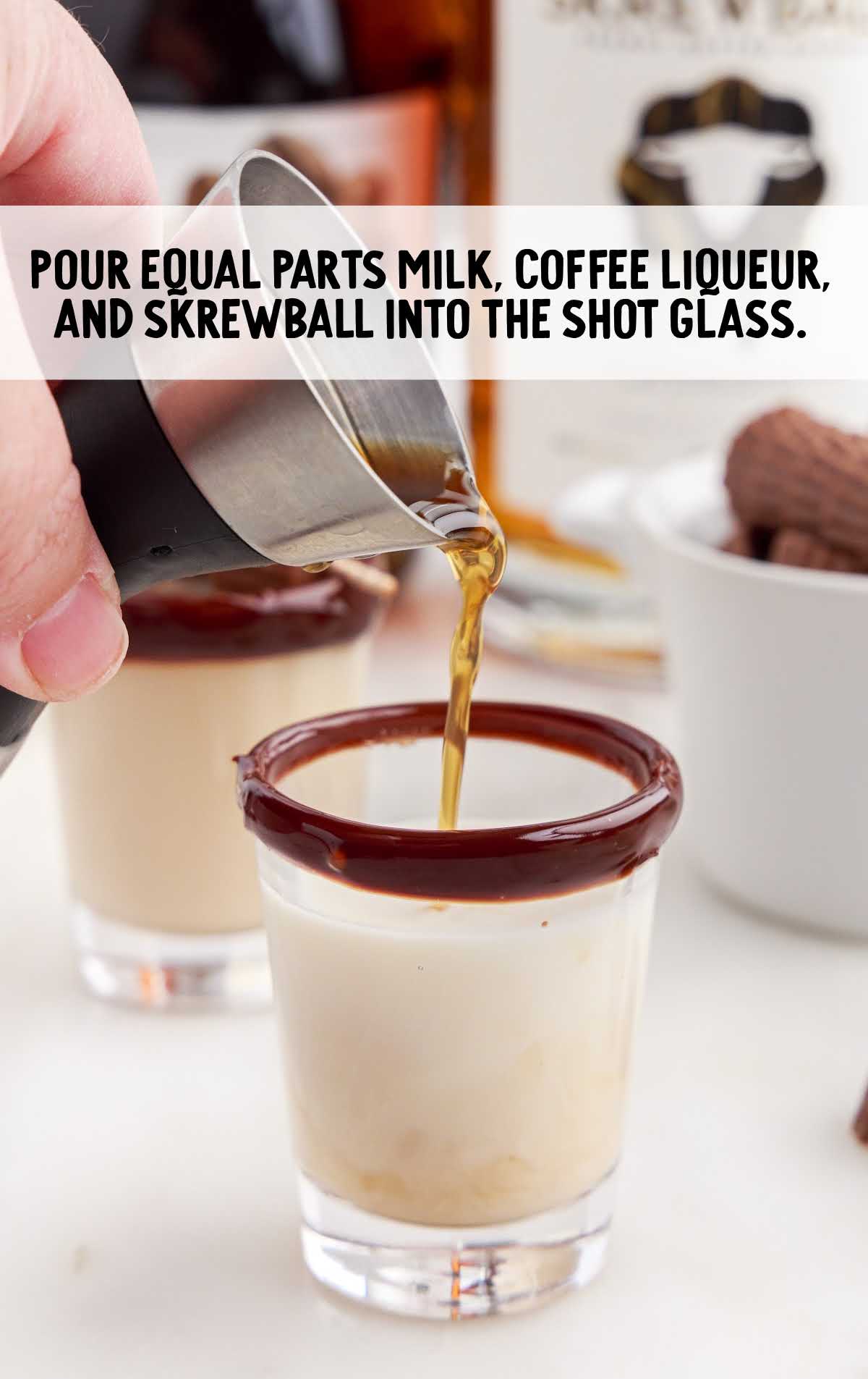 milk, coffee liqueur, and skrewball poured into the shot glass