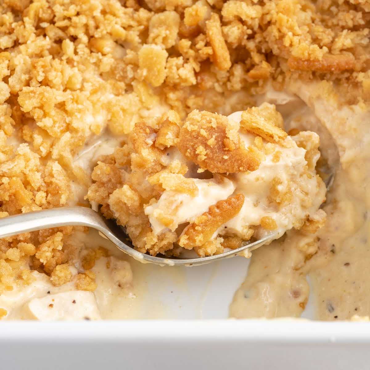 a close up shot of a spoon grabbing a piece of Ritz Cracker Chicken Casserole