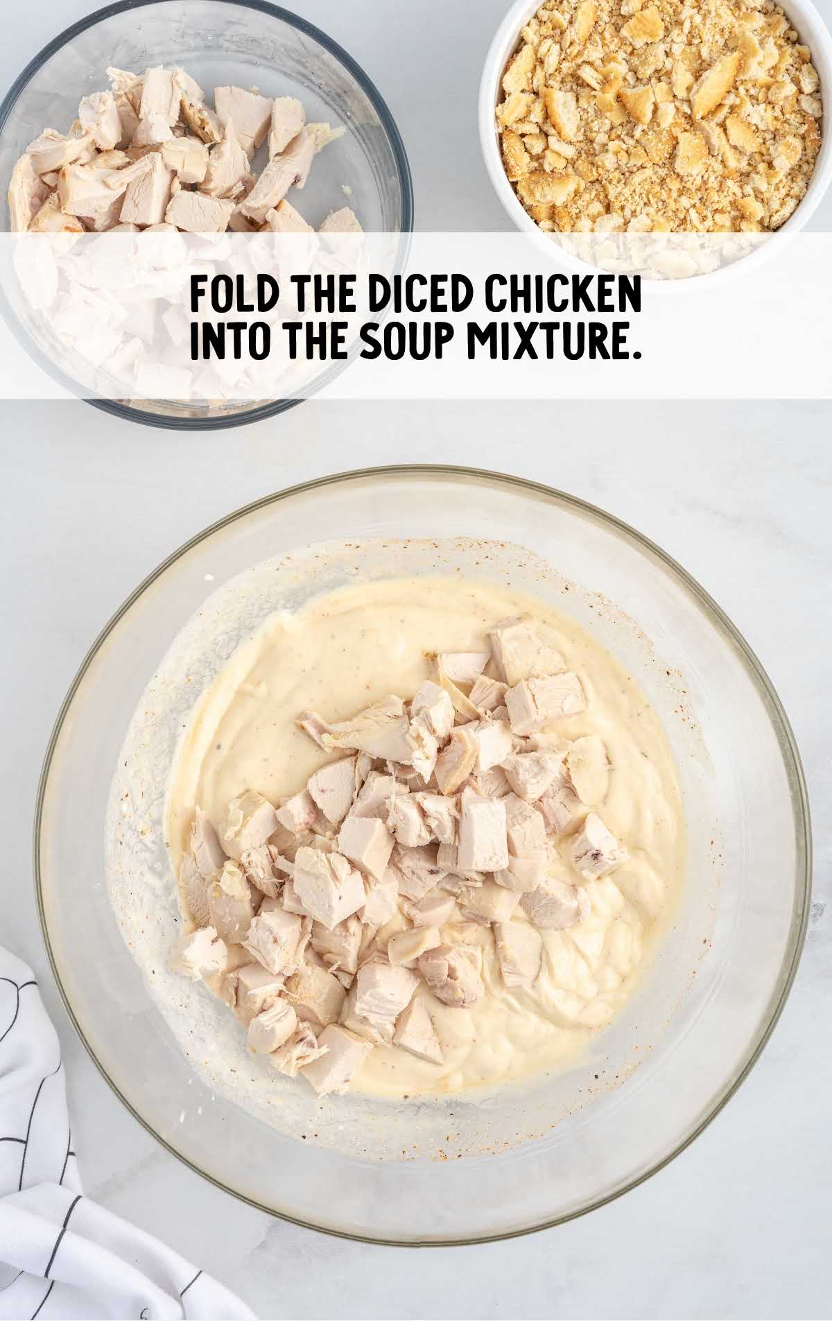 diced chicken folded into the soup mixture in a bowl