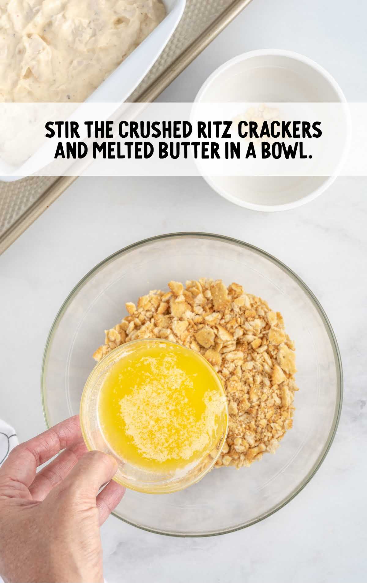 crushed ritz crackers and butter stirred in a bowl