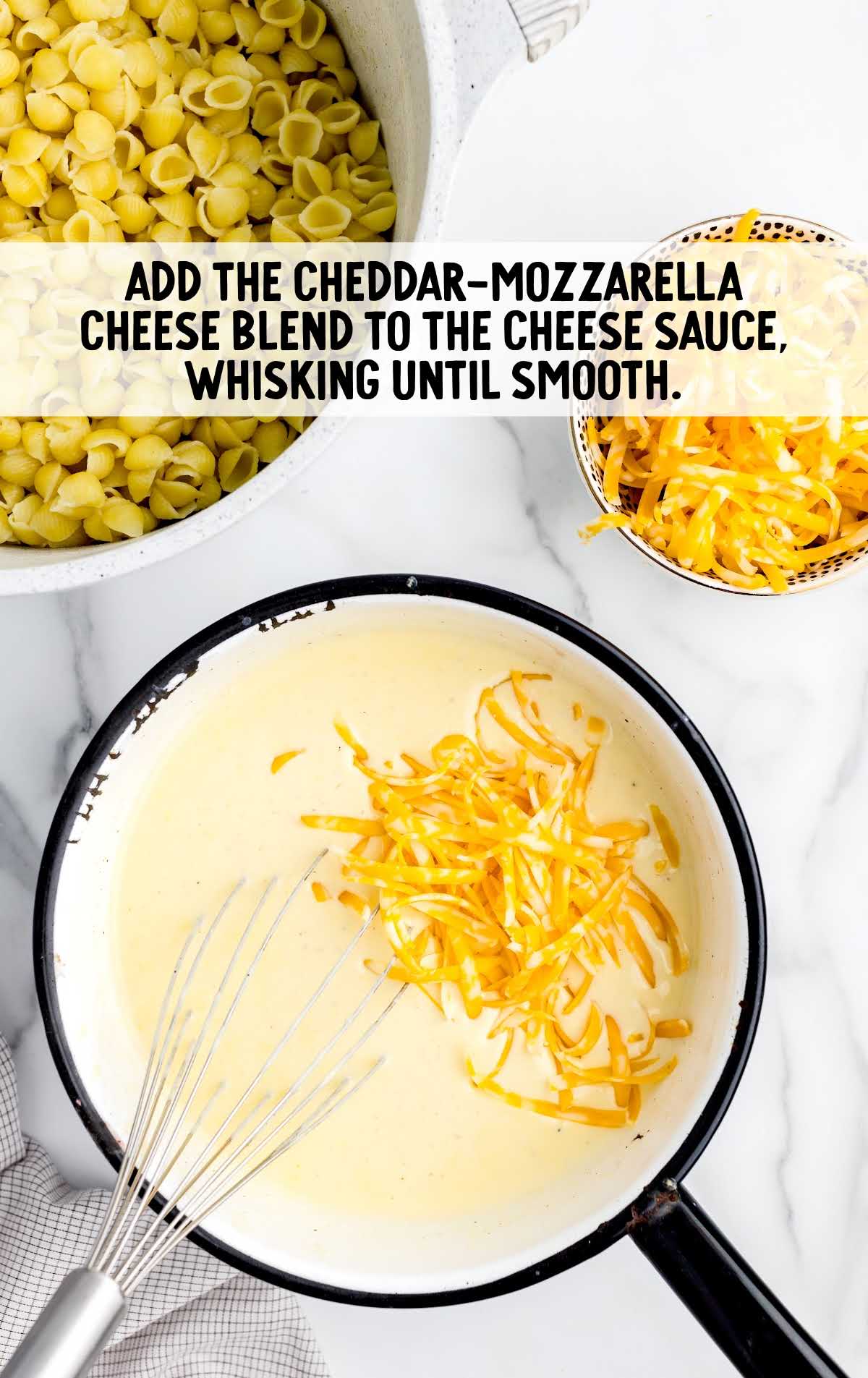 cheddar mozzarella cheese blend added to the cheese sauce and whisked together in a bowl