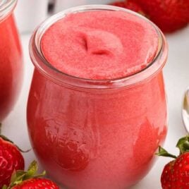 a close up shot of Strawberry Curd in a glass cup