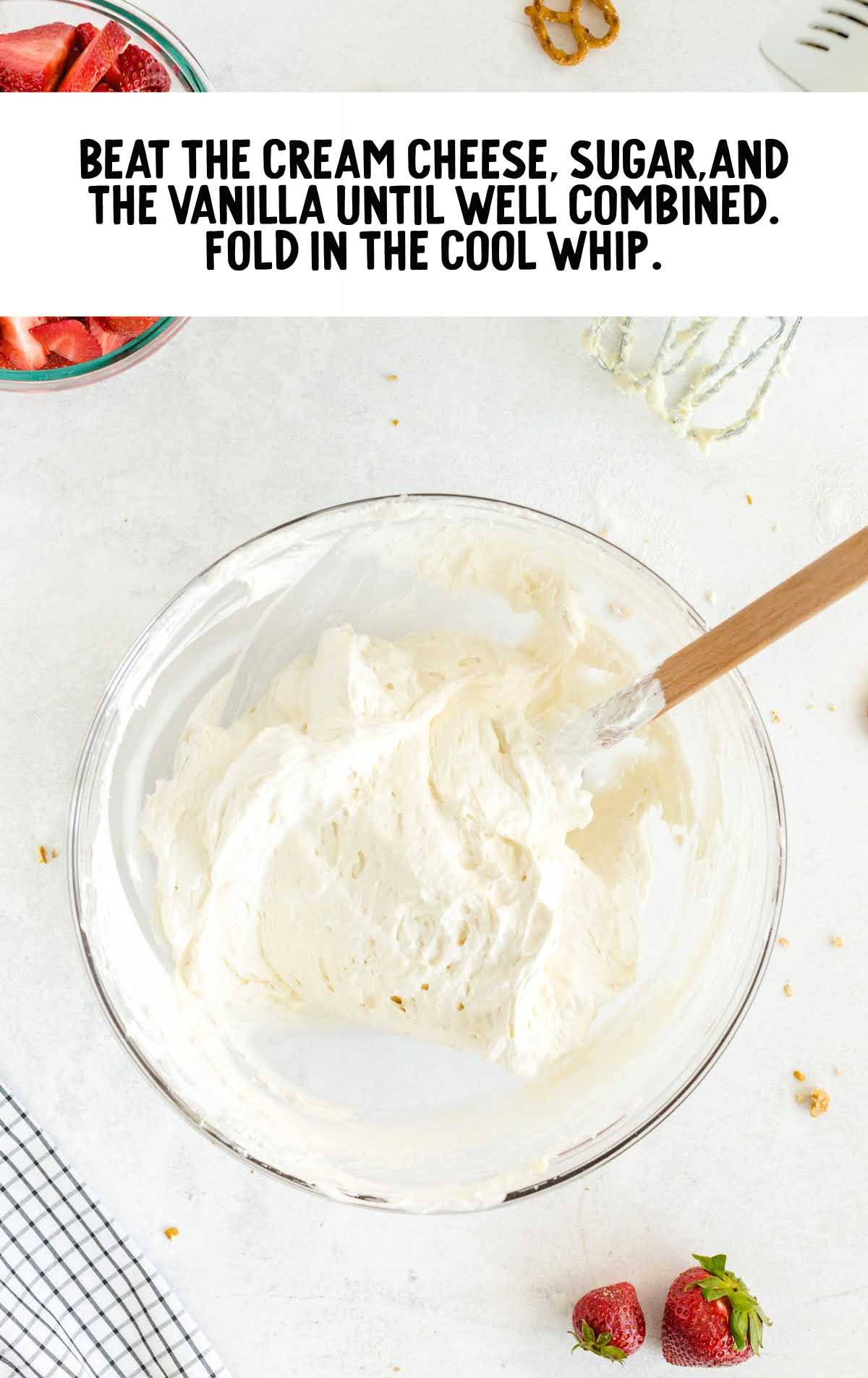 cream cheese, sugar, vanilla and cool whip folded in a bowl